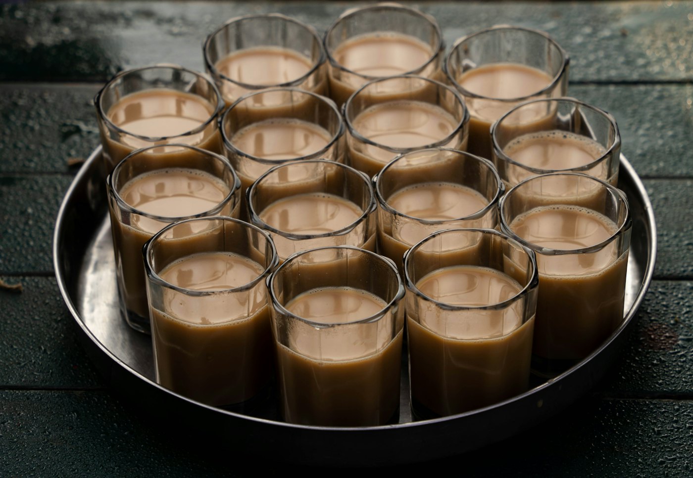Glasses of chai on a metal tray